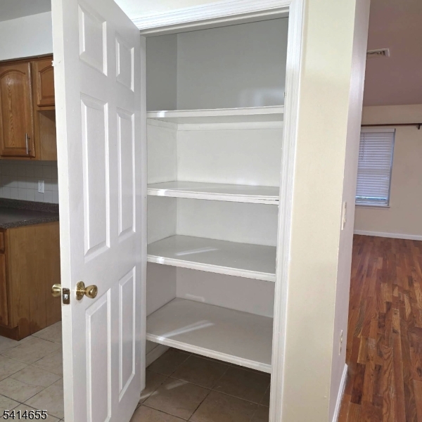 24 Van Vechten Street, Unit 3 Newark, NJ 07114 - Photo 7 of 36 a view of walk in closet with empty racks