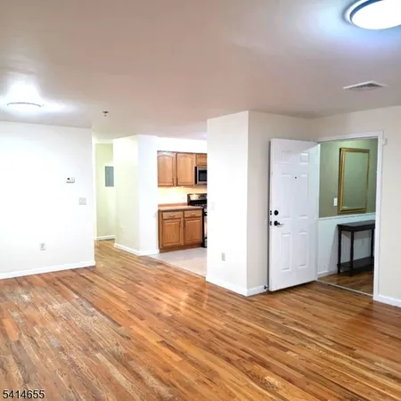 a view of a kitchen cabinets and wooden floor