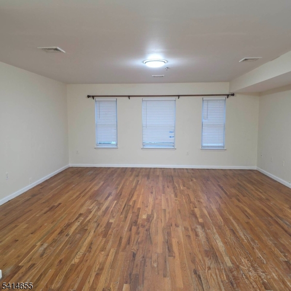 24 Van Vechten Street, Unit 3 Newark, NJ 07114 - Photo 10 of 36 a view of empty room with wooden floor and fan