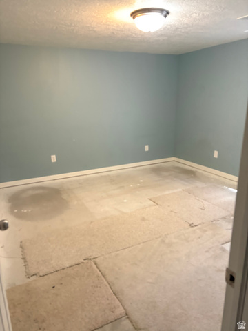 587 West 2400 South Perry, UT 84302 - Photo 39 of 46 Room featuring light blue walls, white baseboards, and a ceiling-mounted light fixture
