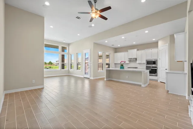 a view of a kitchen with a sink and a refrigerator