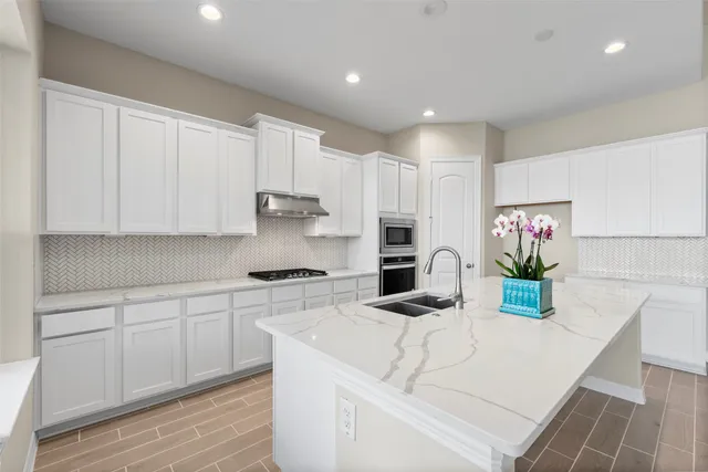 a kitchen with kitchen island white cabinets and white appliances