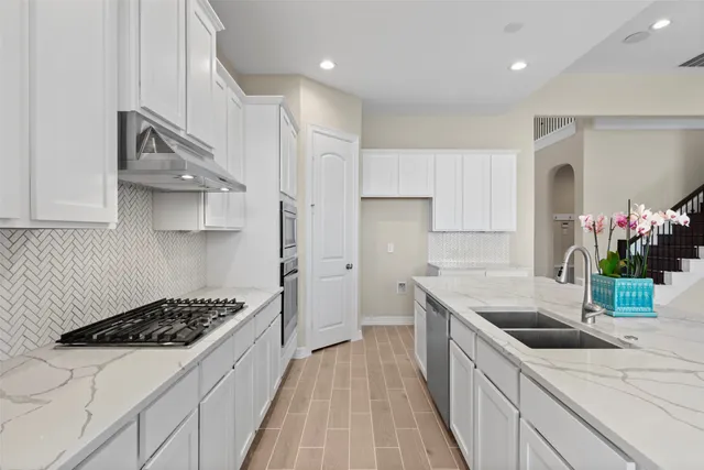 a kitchen that has a sink and a stove