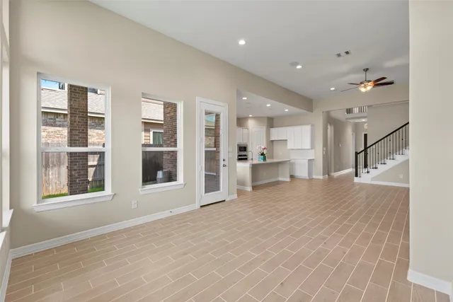 a view of a kitchen with stainless steel appliances refrigerator and window