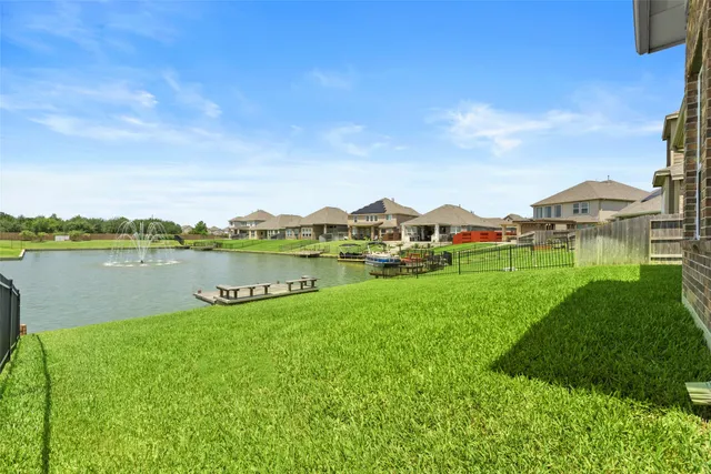 a view of a house with a yard and a lake view