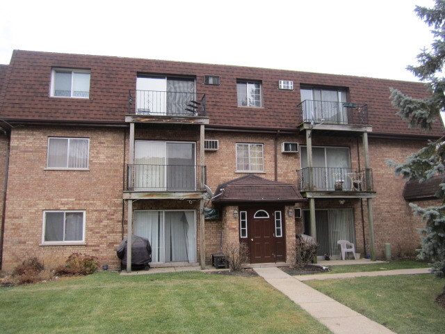 115 East Dundee Road, Unit 2N Wheeling, IL 60090 - Photo 1 of 16 a front view of a building with a garden