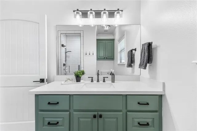 a bathroom with a sink vanity and a mirror