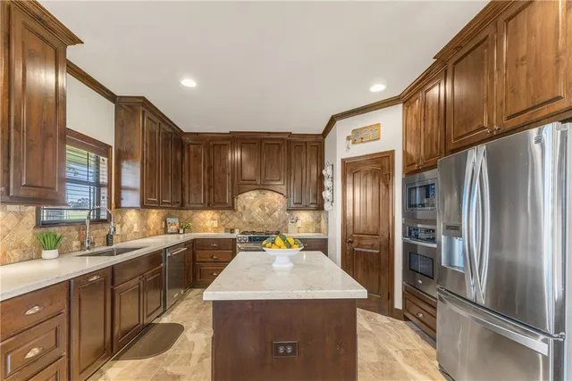 a kitchen with a sink refrigerator and cabinets