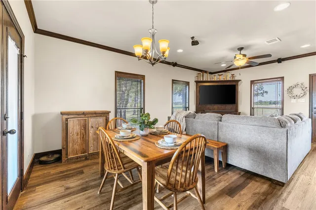 a view of a dining room with furniture wooden floor and chandelier