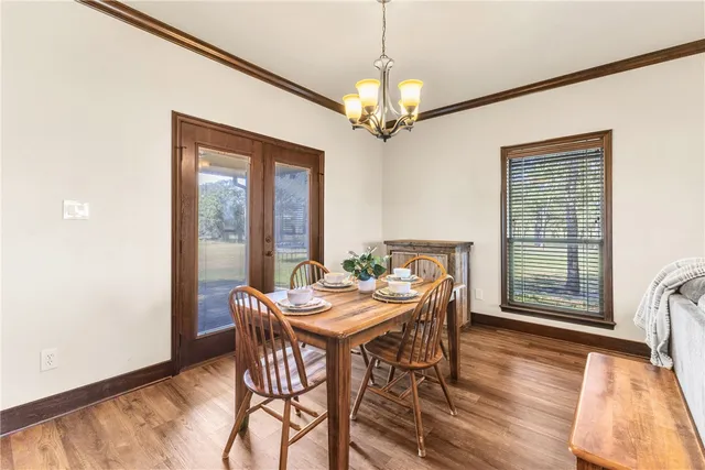a view of a dining room with furniture wooden floor and chandelier