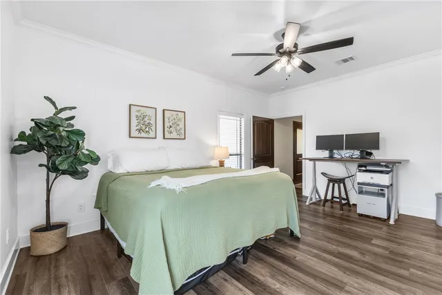 a bedroom with a large bed and a chandelier