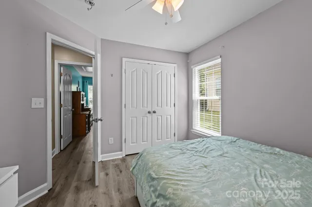 a view of a hallway with wooden floor and entryway