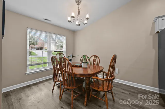 a view of a dining room with furniture and chandelier