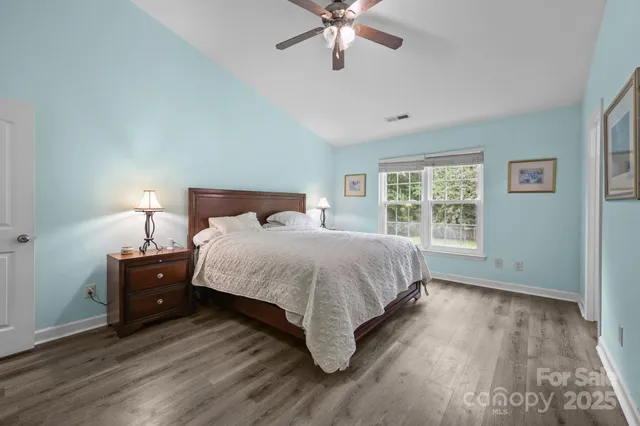 a bedroom with a bed and a lamp