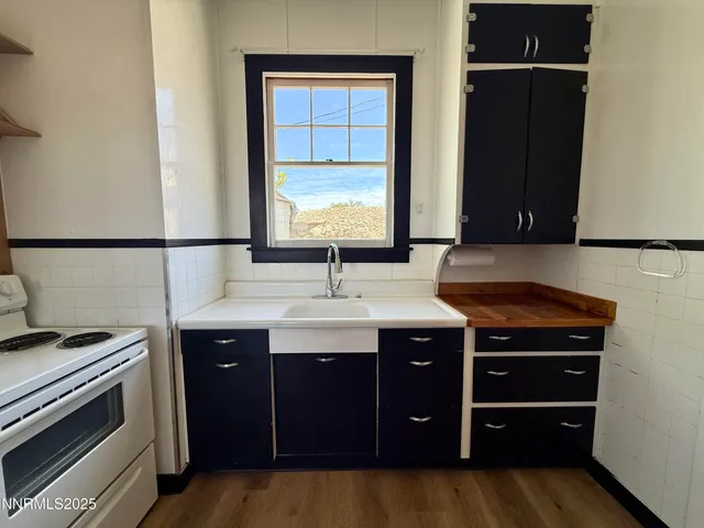 a kitchen with stainless steel appliances a refrigerator sink and stove