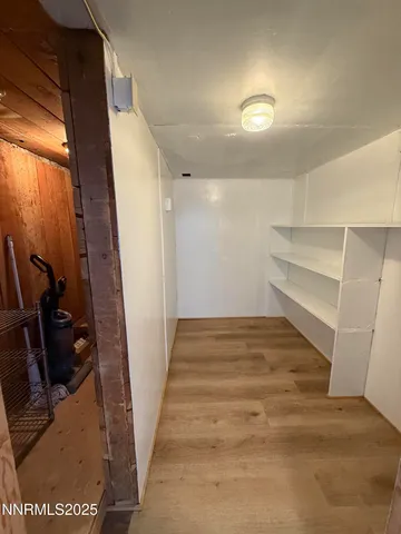 a view of a living room with a flat screen tv and refrigerator