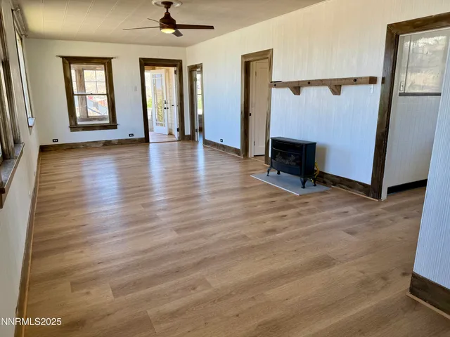 a view of a hallway with wooden floor and a fireplace