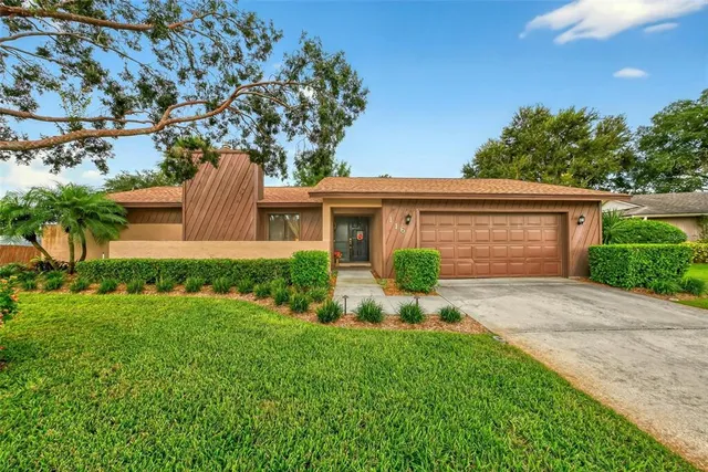 a front view of house with yard and green space