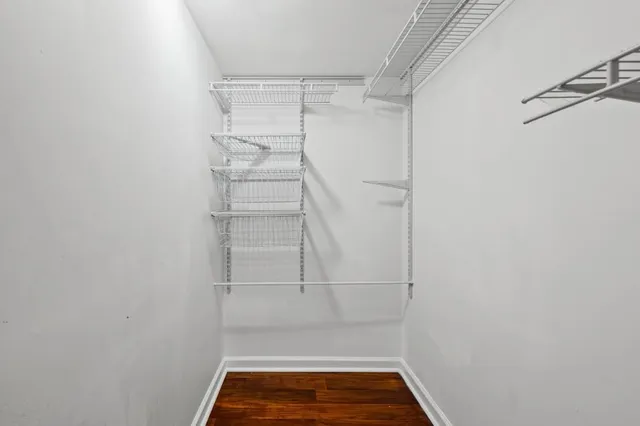 a view of walk in closet with empty racks