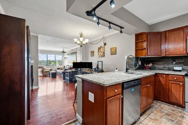 a kitchen with a counter top space a sink cabinets and appliances