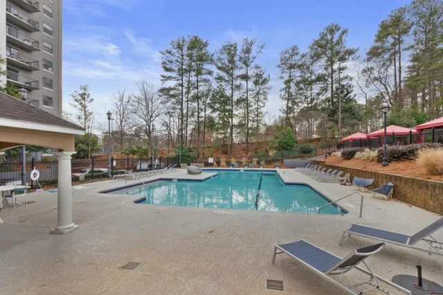 a view of a patio with a table chairs and a backyard