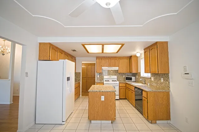 a large kitchen with a large window and stainless steel appliances