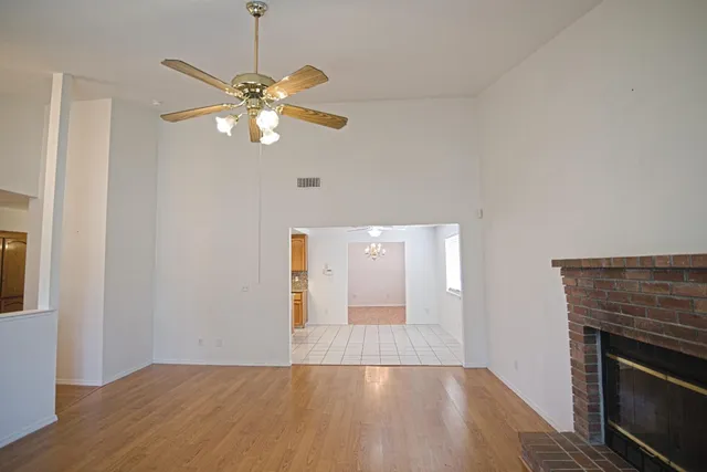a view of empty room with wooden floor