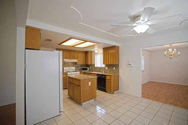 a kitchen with cabinets and window