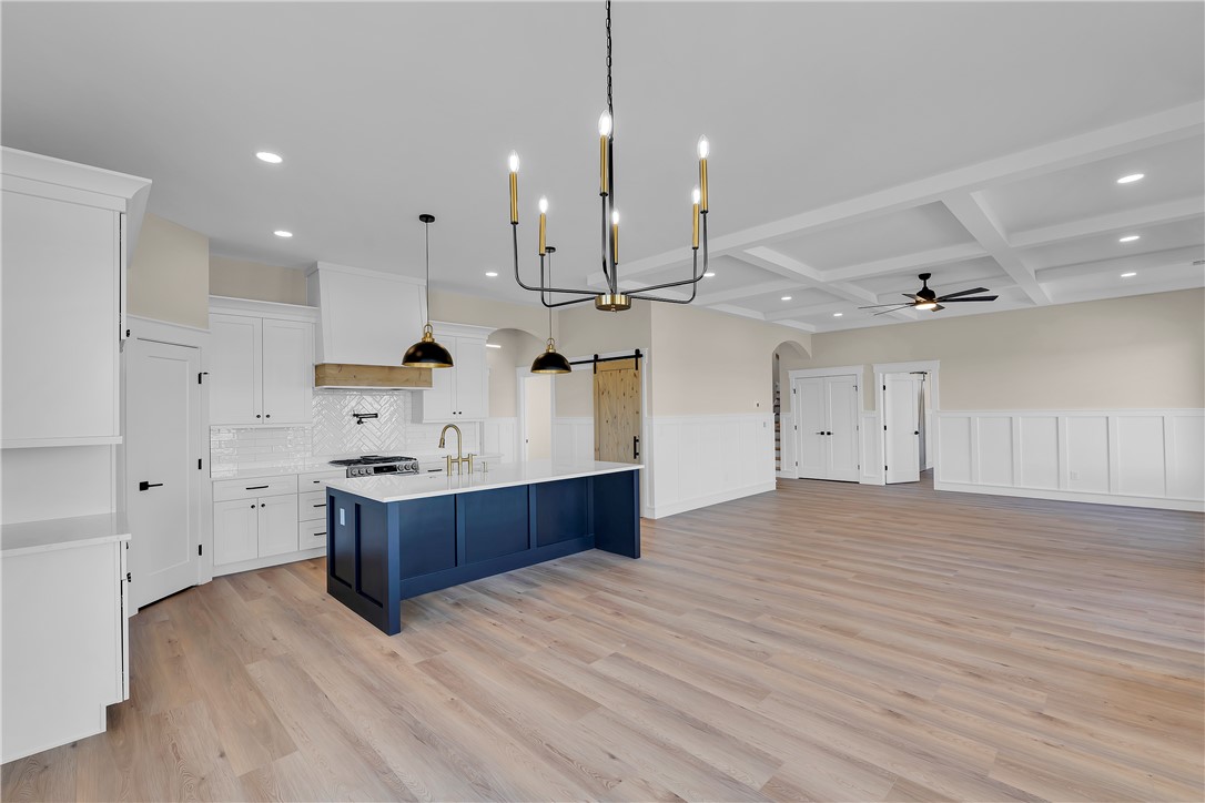 2816 Smith McGee Road Iva, SC 29655 - Photo 20 of 25 A spacious, airy kitchen and living area featuring a central island, recessed lighting, and a coffered ceiling.