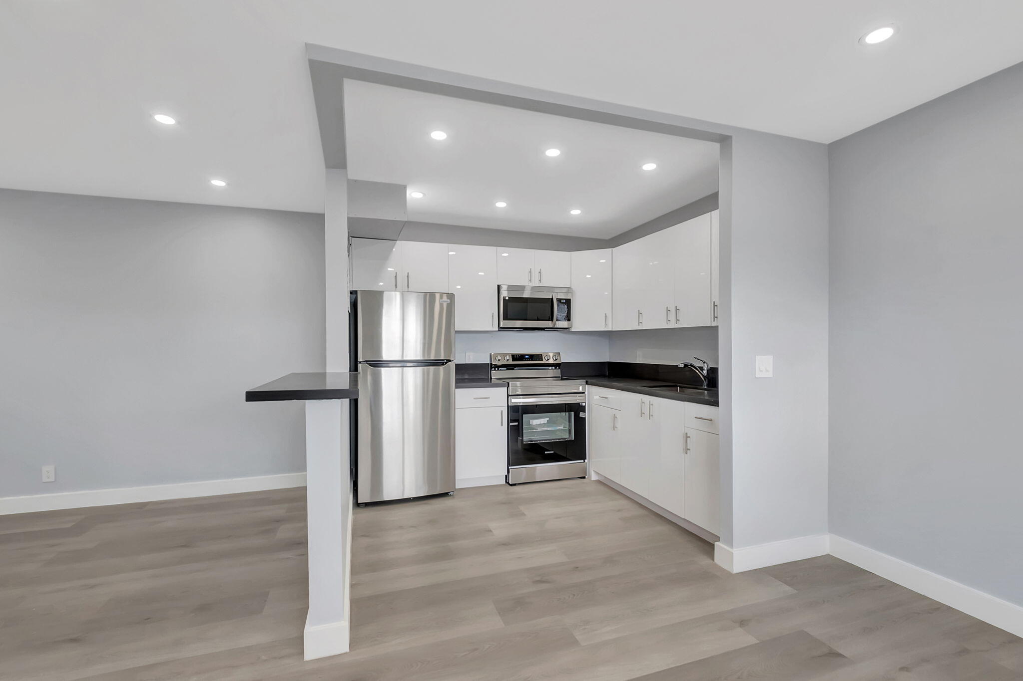 171 Monaco Way Delray Beach, FL 33446 - Photo 13 of 58 a kitchen with stainless steel appliances granite countertop a refrigerator and a stove top oven