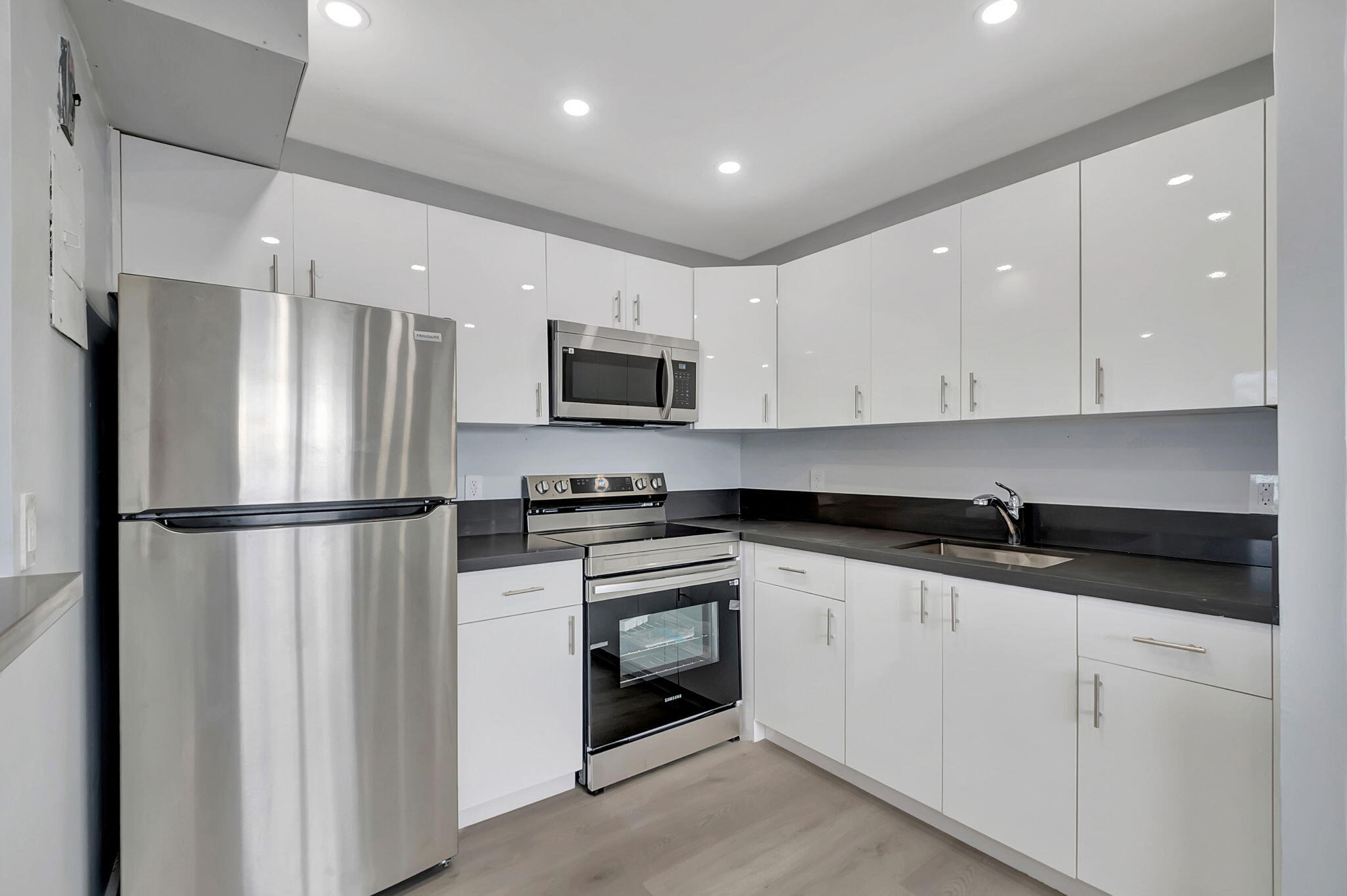 171 Monaco Way Delray Beach, FL 33446 - Photo 15 of 58 a kitchen with granite countertop white cabinets and refrigerator