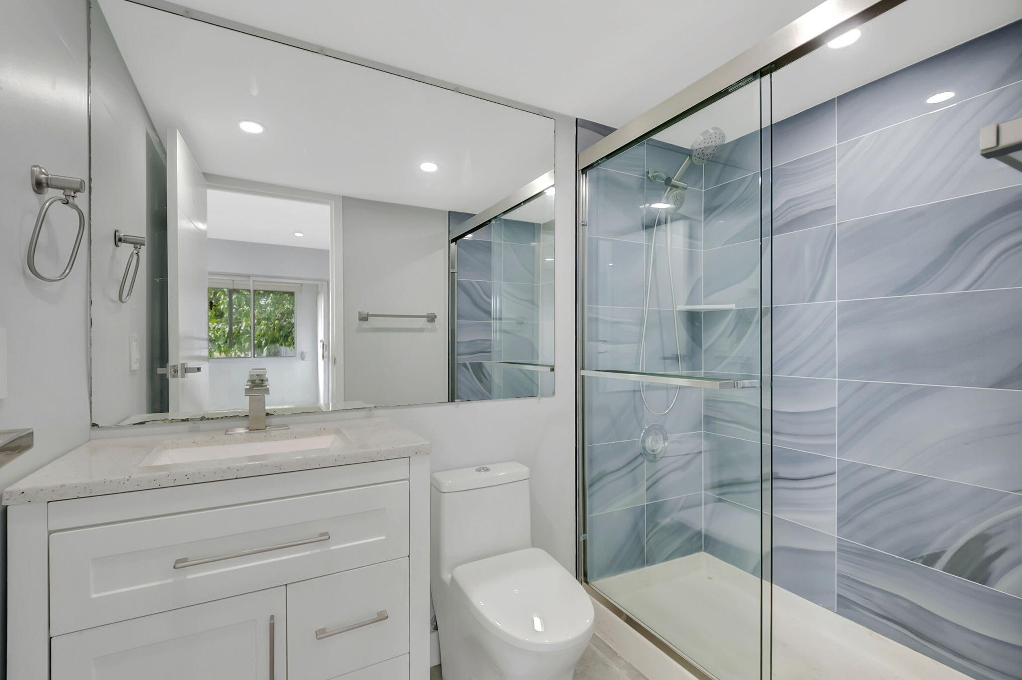 171 Monaco Way Delray Beach, FL 33446 - Photo 21 of 58 a bathroom with a shower sink vanity mirror and toilet