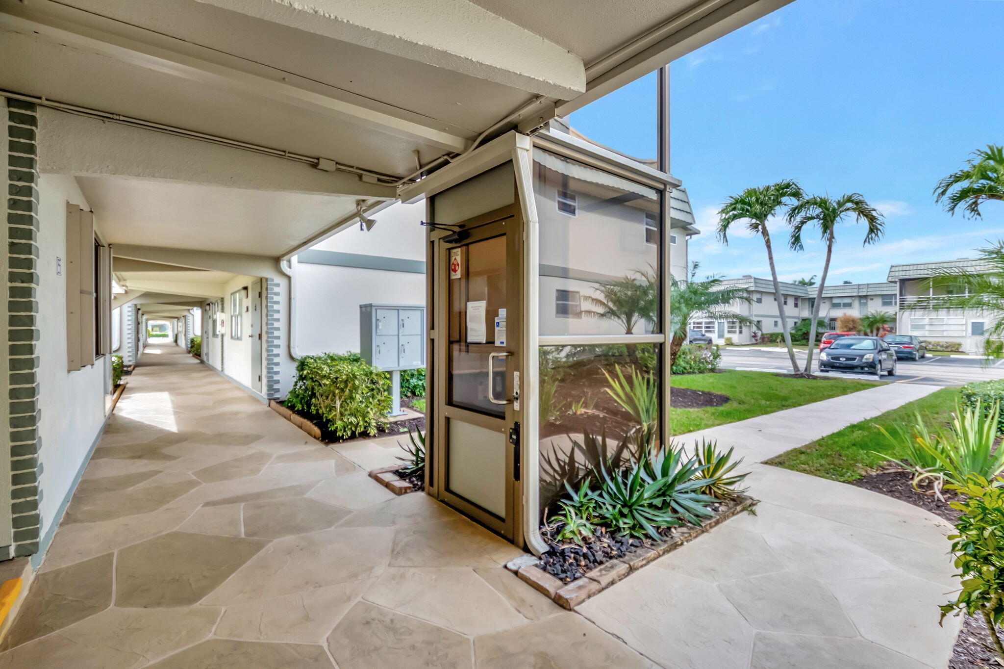 171 Monaco Way Delray Beach, FL 33446 - Photo 4 of 58 a view of a patio with a table and chairs under an umbrella