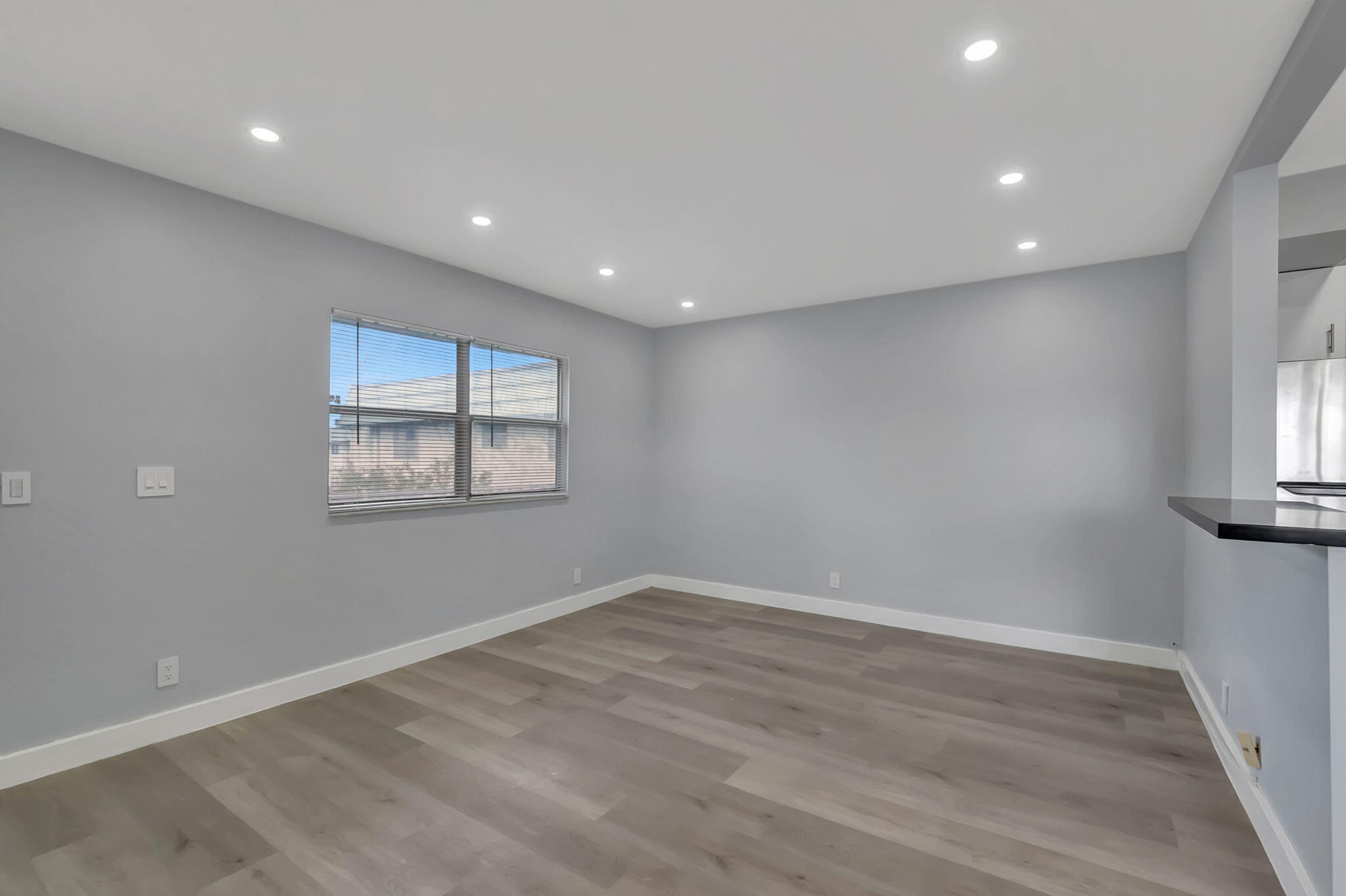 171 Monaco Way Delray Beach, FL 33446 - Photo 7 of 58 a view of empty room with wooden floor and fan
