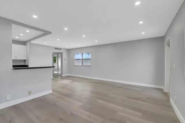 a view of kitchen with granite countertop cabinets and wooden floor