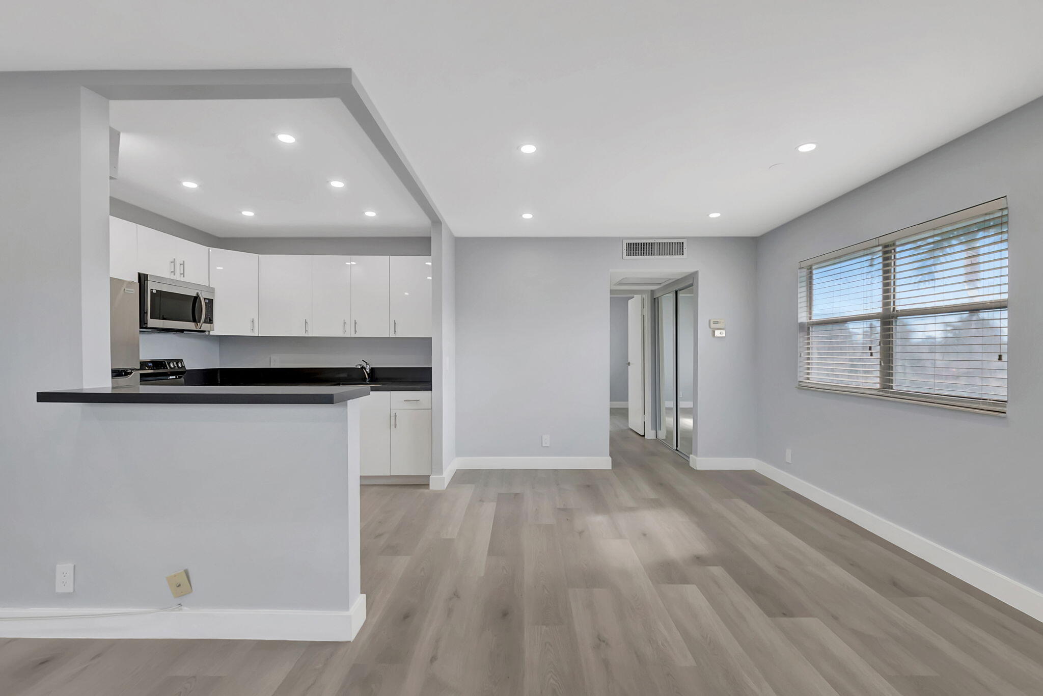 171 Monaco Way Delray Beach, FL 33446 - Photo 9 of 58 a view of kitchen with granite countertop cabinets and wooden floor
