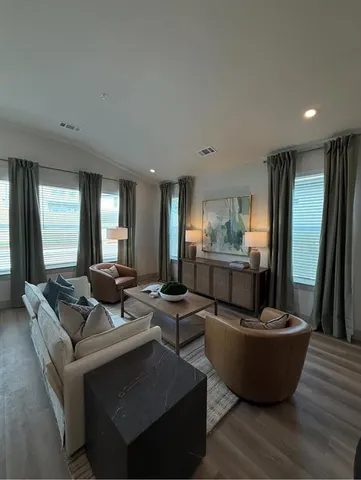 a living room with furniture and a potted plant