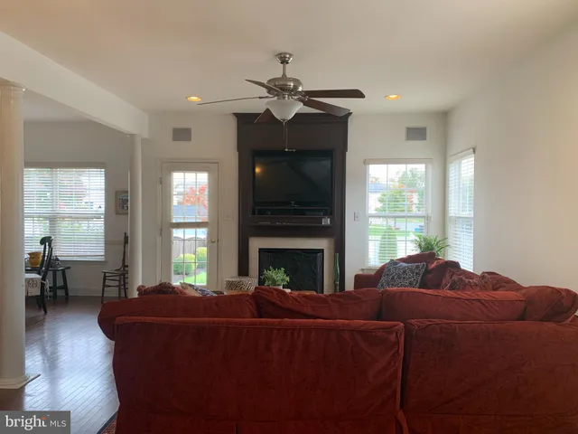 a living room with furniture a fireplace and a large window