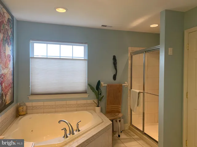 a bathroom with a tub and shower