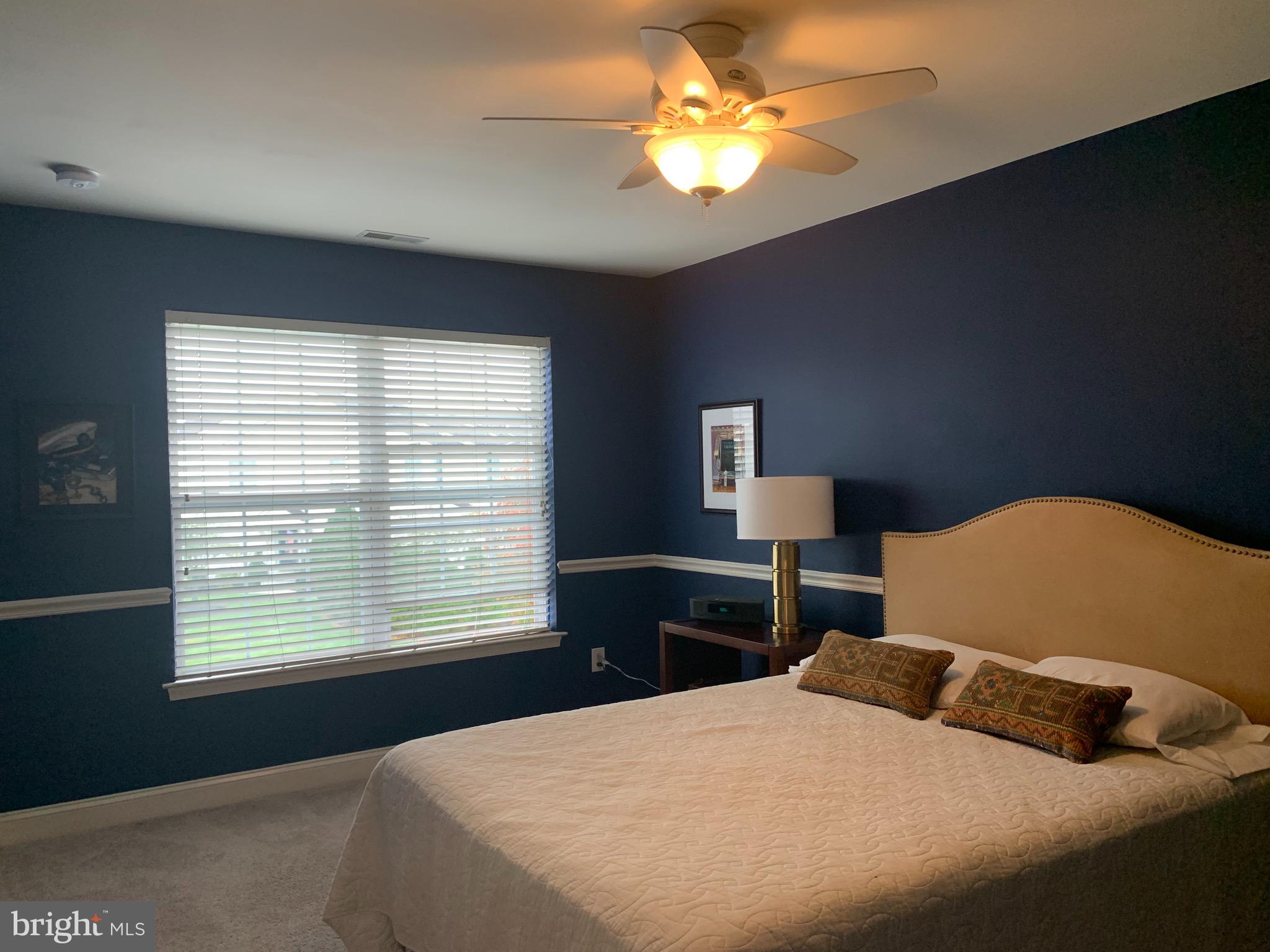 2 Zion Drive Berlin, NJ 08009 - Photo 26 of 37 a bedroom with a bed and a chandelier