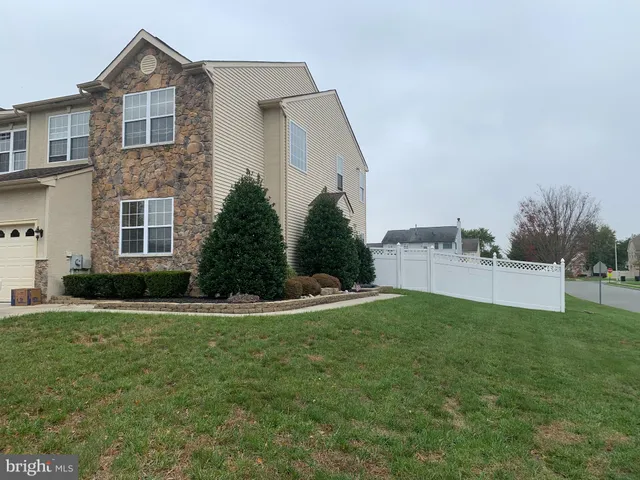 a view of a house with a yard and garage