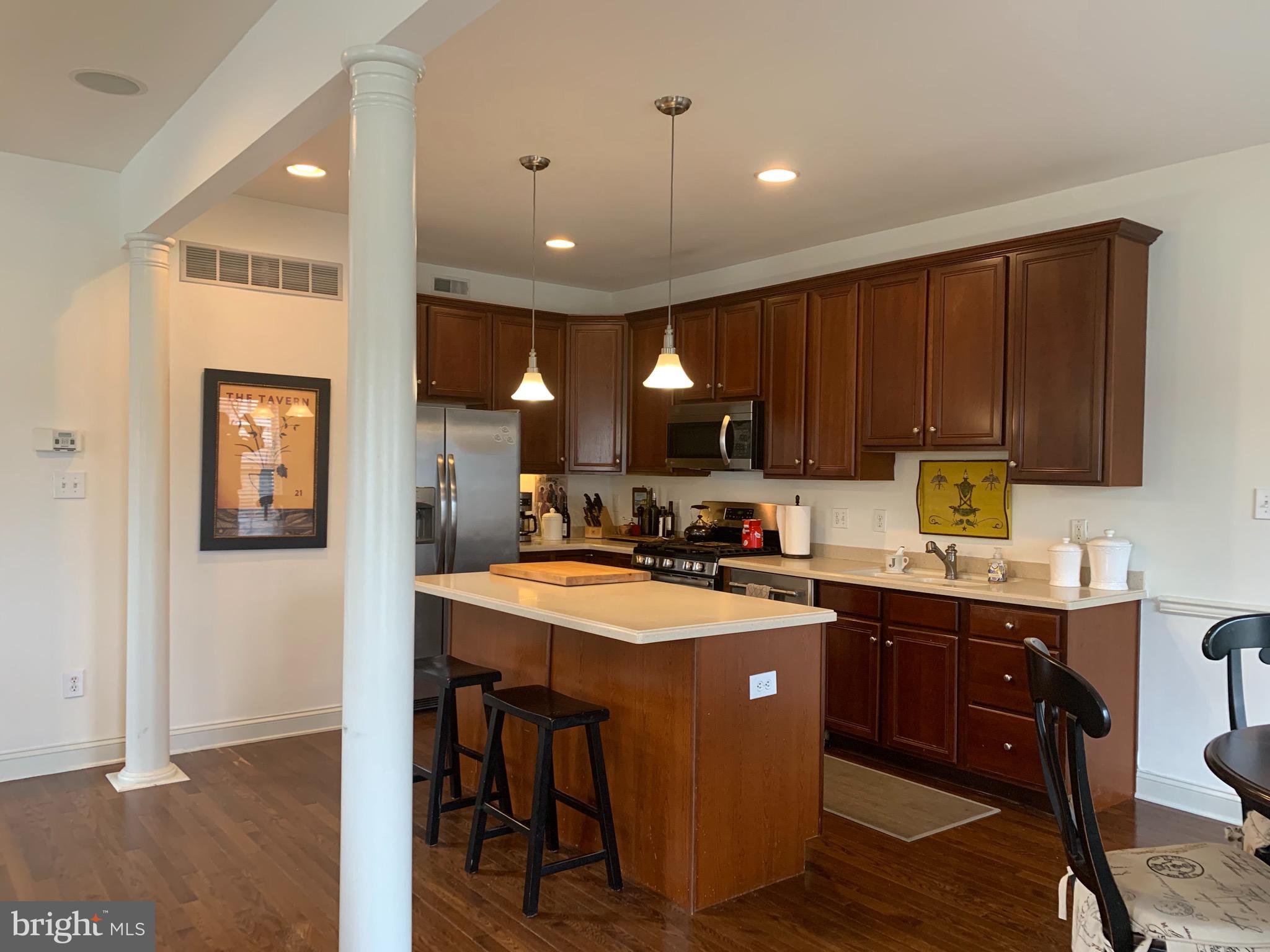 2 Zion Drive Berlin, NJ 08009 - Photo 7 of 37 a kitchen with kitchen island granite countertop a sink appliances and cabinets
