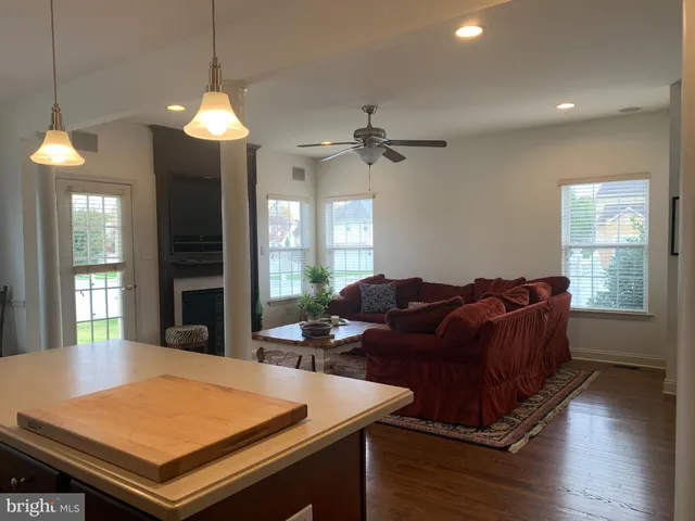 a living room with furniture a chandelier and a table