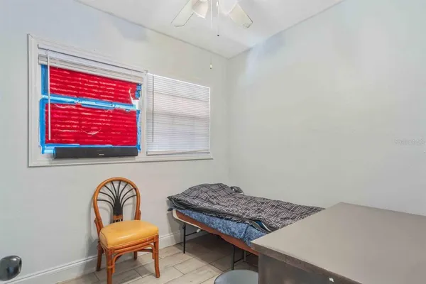 a bedroom with furniture and a wooden floor