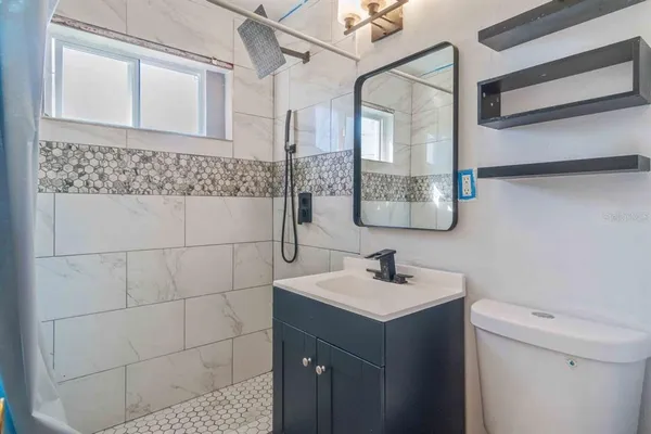 a kitchen with stainless steel appliances granite countertop a refrigerator a sink and dishwasher