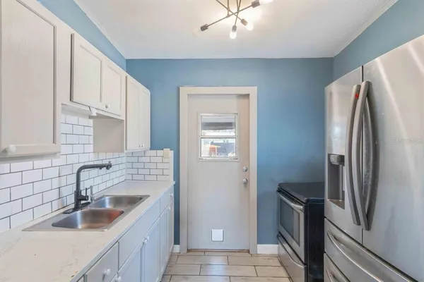 a kitchen with a sink cabinets and window