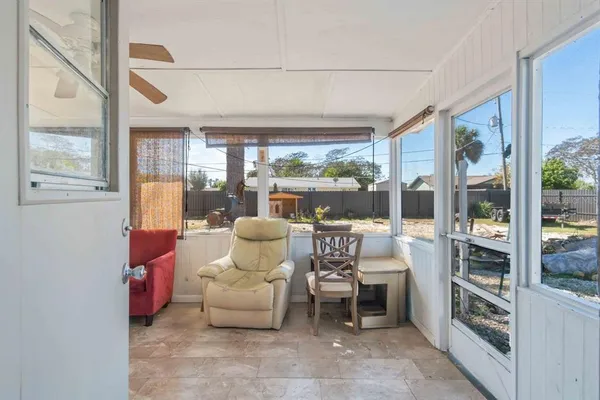 a living room filled with furniture and a large window