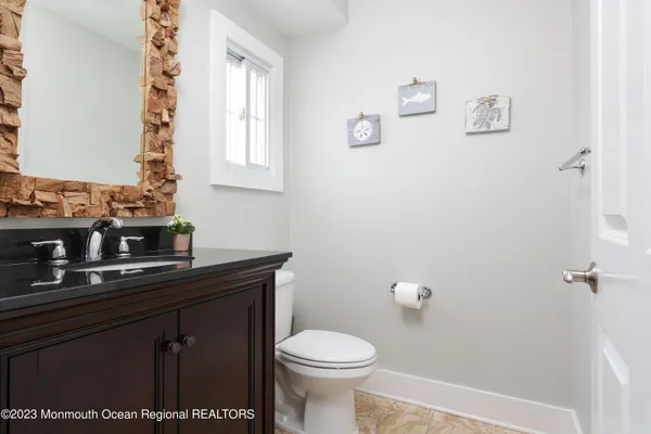 a bathroom with a sink a toilet and a window