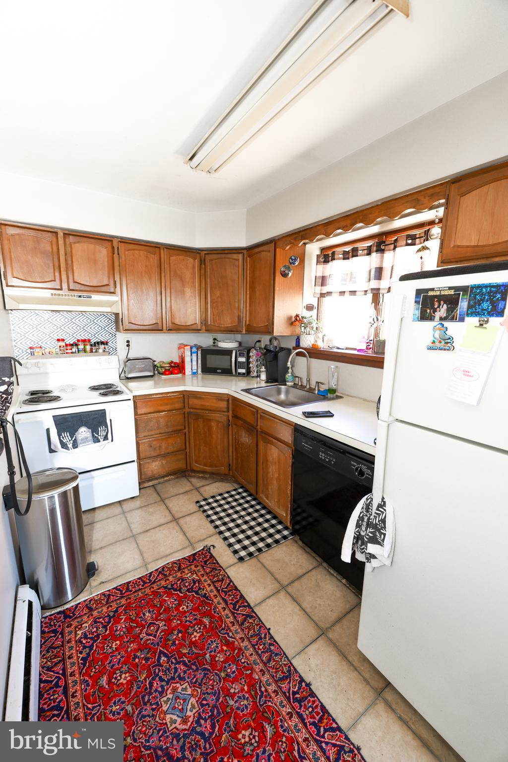 232 Long Lane Upper Darby, PA 19082 - Photo 12 of 29 a kitchen with a sink a stove a refrigerator and a stove