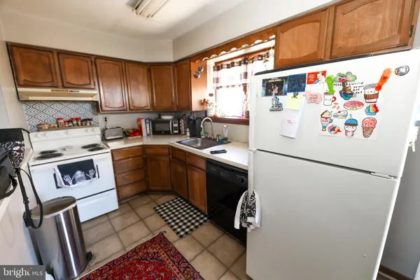 a white refrigerator freezer sitting inside of a kitchen
